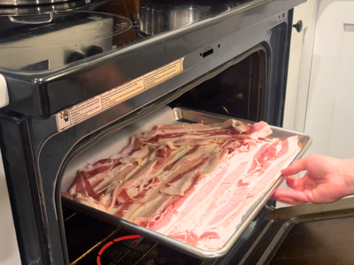 putting bacon into the oven.
