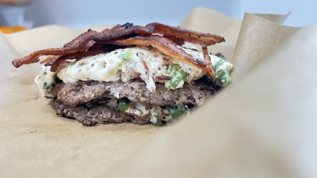 finished smash burger sitting on parchment paper