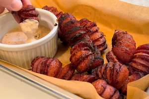 dipping kielbasa bites into finished sauce