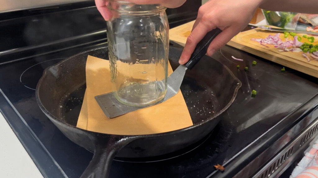 smashing burgers with a spatula and mason jar